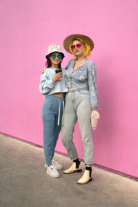 young-women-with-dyed-hair-near-pink-wall